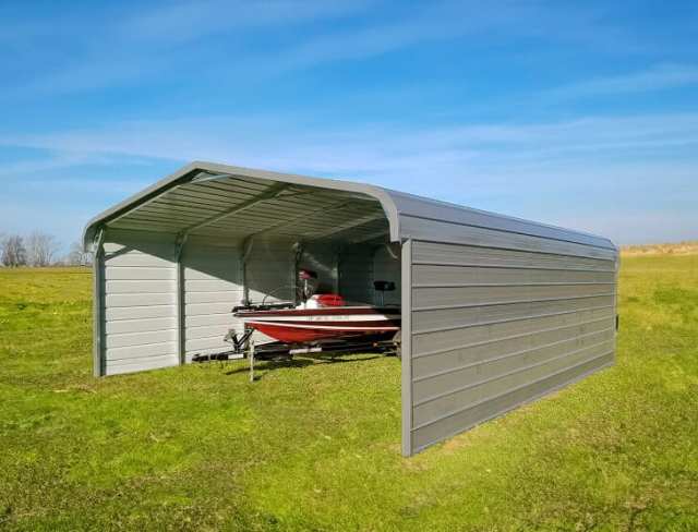 Boat carport on a grass field.