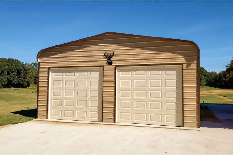 A beige garage with two beige garage doors.