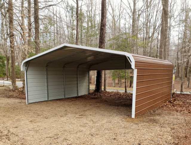 A brown carport surrounded by trees.