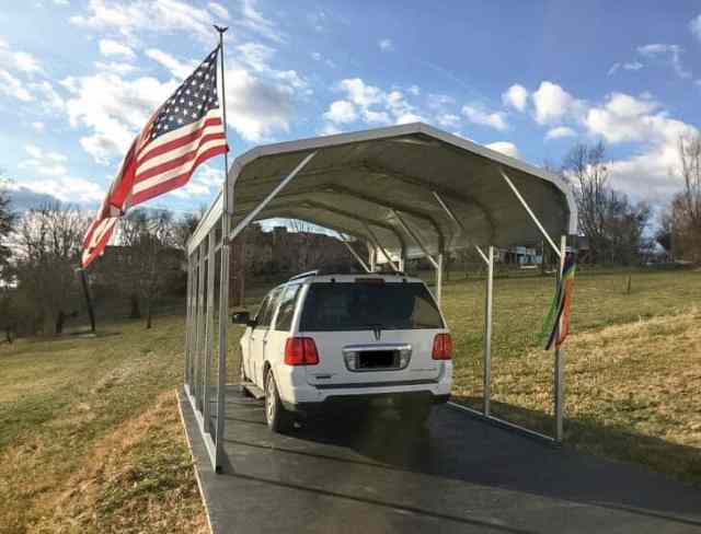 A small carport with an American flag attached to it.