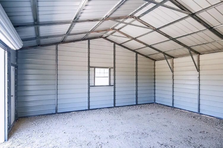 An inside view of a garage showing the concrete slab foundation.