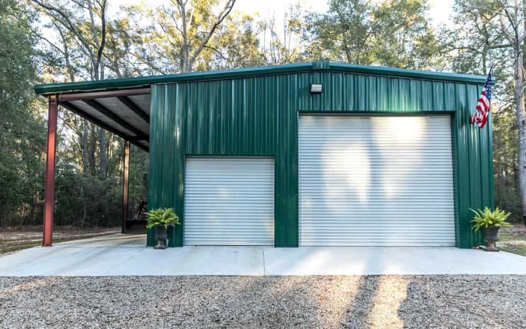 green metal building with lean-to carport addition