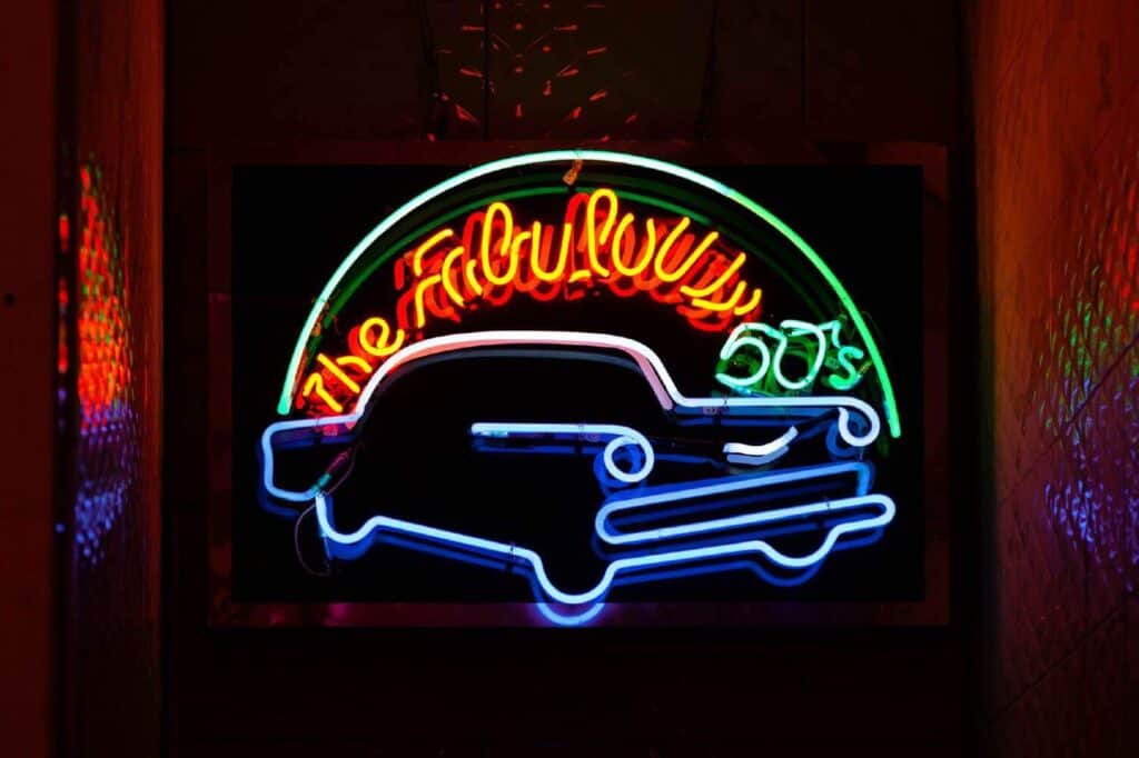 mounted neon sign on a colorful wall