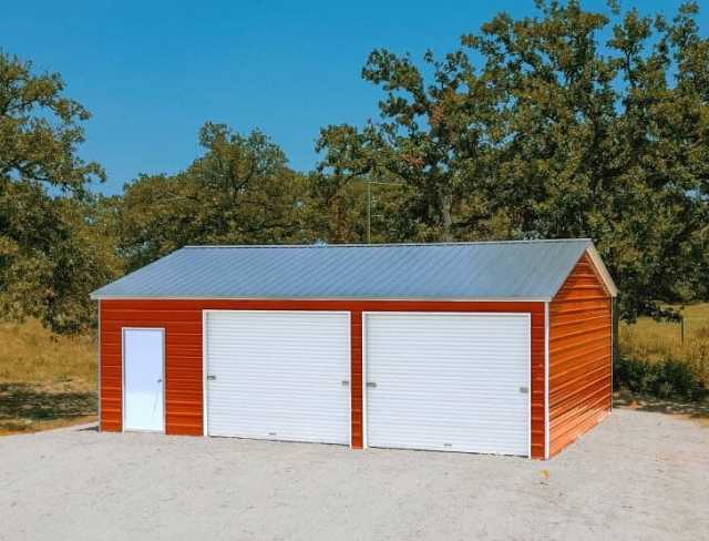 A red garage with two garage doors and a walk in door.