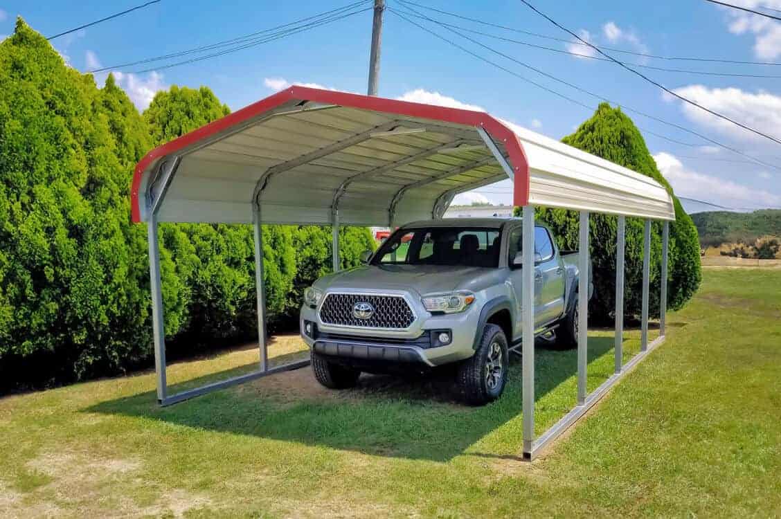 A carport with a regular roof covering a pickup truck.