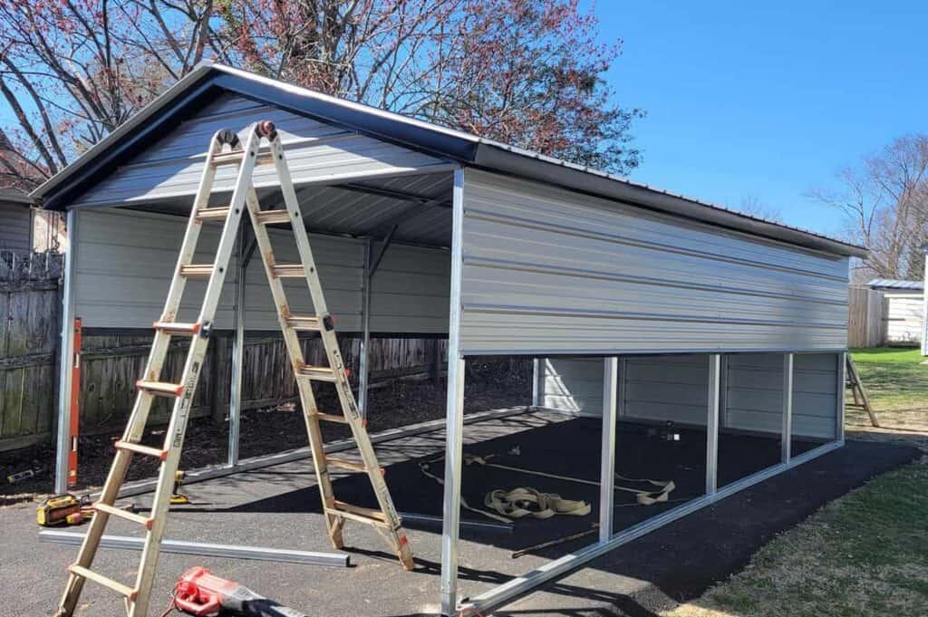 newly installed metal carport with ladder beside it