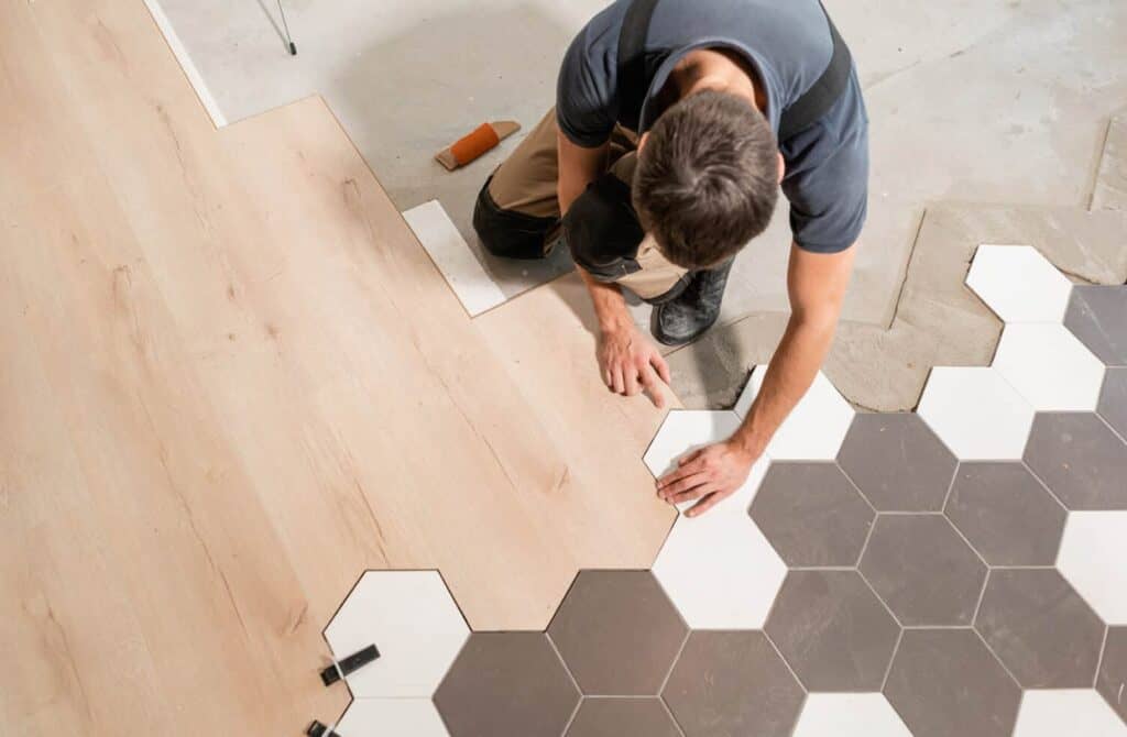 a contractor installing flooring in a garage