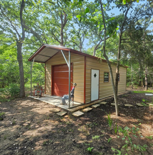 Small garage surrounded by trees