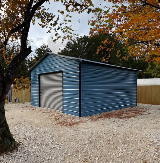 Blue garage surrounded by trees