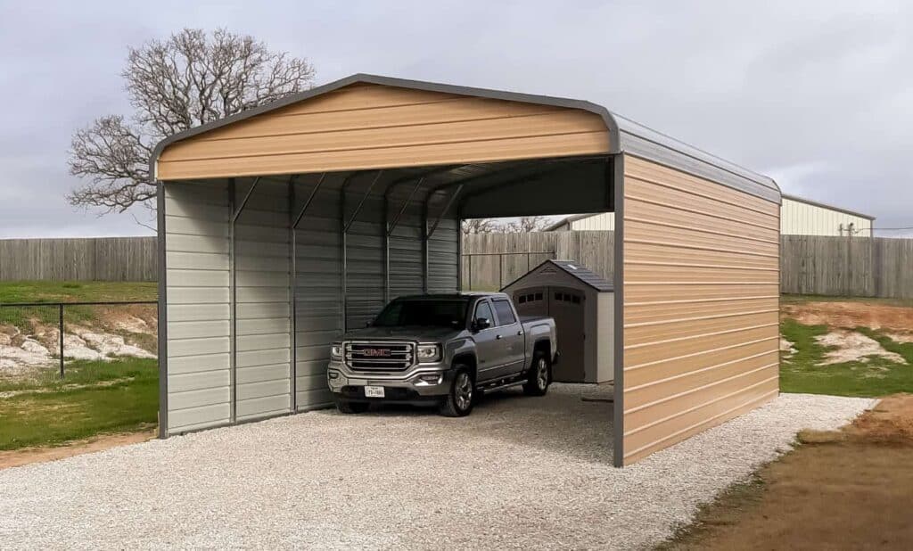 A sturdy metal carport shelters a pickup truck.