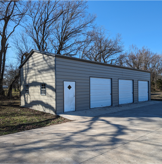 Garage with 3 garage doors and a walk in door