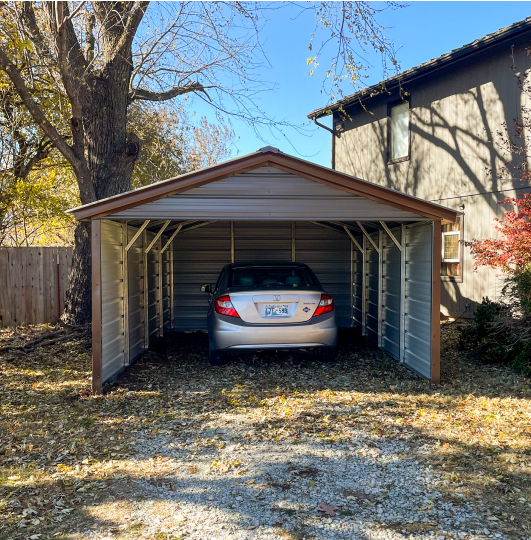 Carport with closed sides and a car inside of it