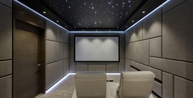Home theater room with acoustic panels, created inside a metal garage