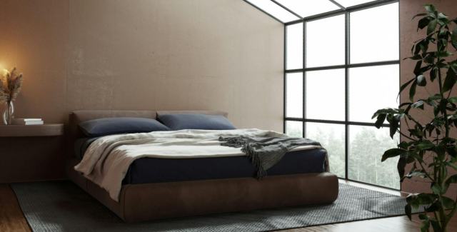 Spacious sleeping area concept inside a finished metal garage with large windows