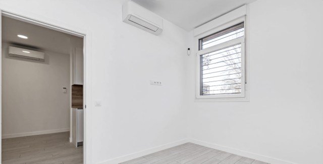 Minimalist empty room with air conditioning and a window