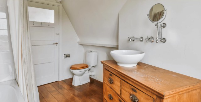 Rustic bathroom with a wooden vanity and a vintage sink