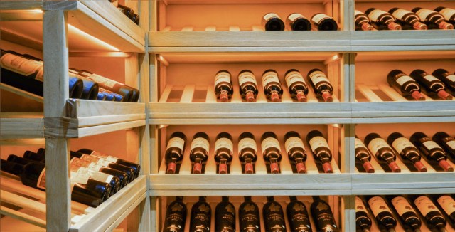 Wine cellar with neatly arranged bottles on wooden shelves