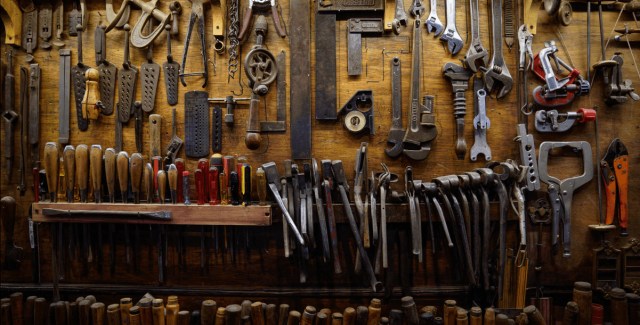 Tool collection displayed on a wooden wall