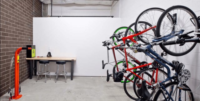 Bicycle workshop with tools, racks, and multiple bikes