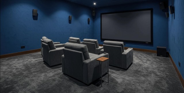 Home theater with blue walls and comfortable recliners