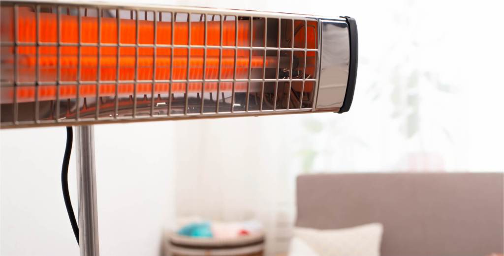 Infrared space heater glowing orange in a living room