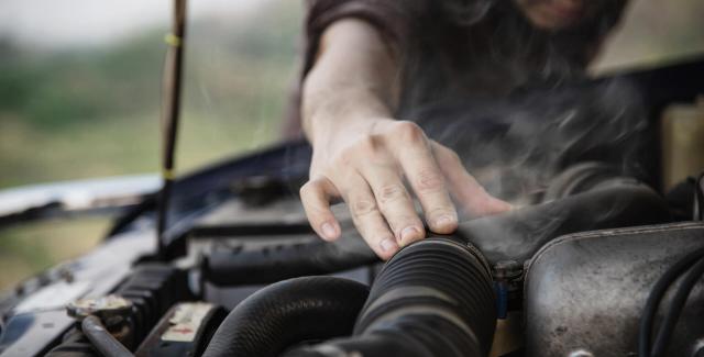 A man working on an RV engine