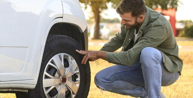 man checking the tires on his RV