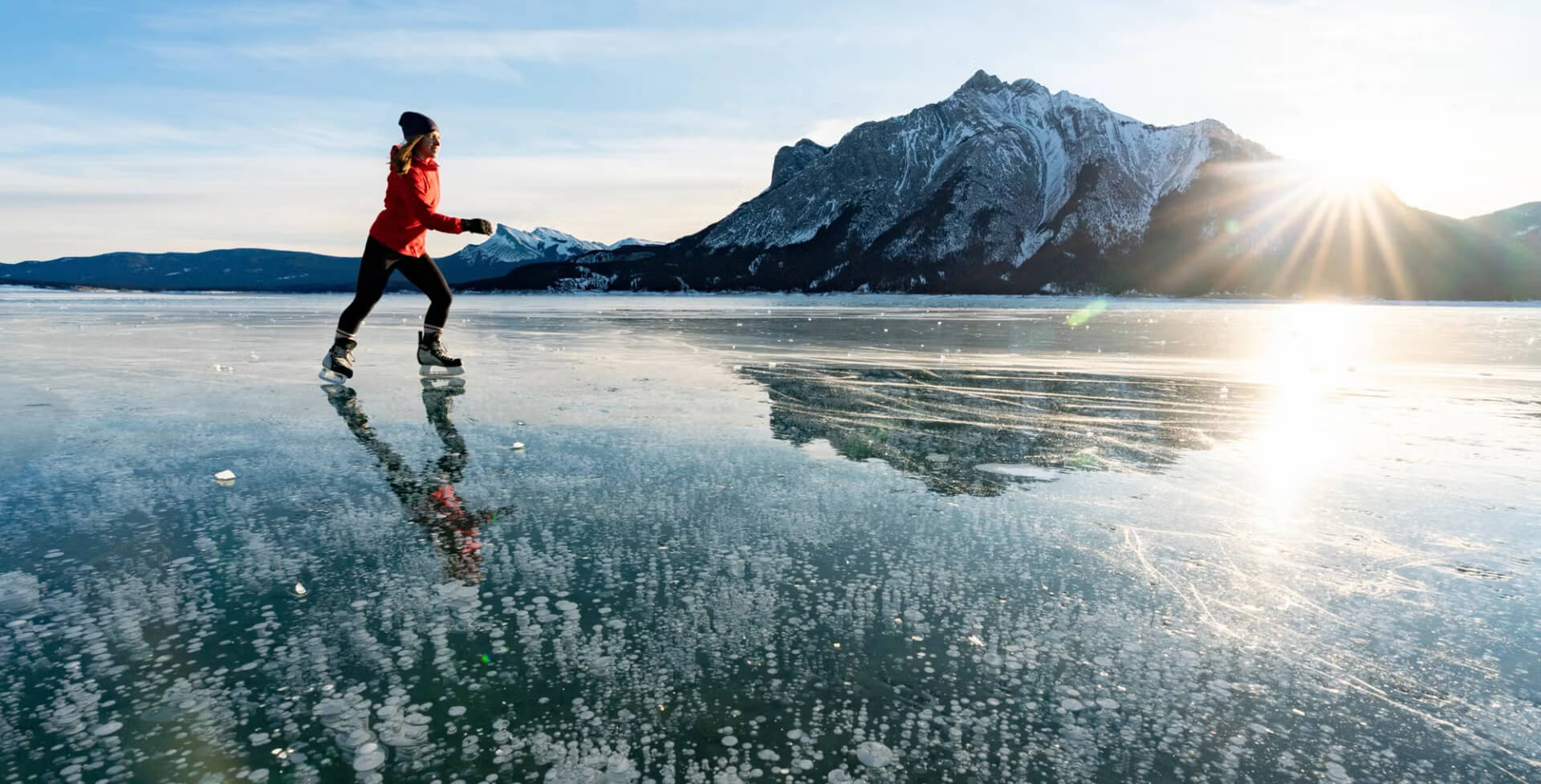 A person skating on a frozen lake