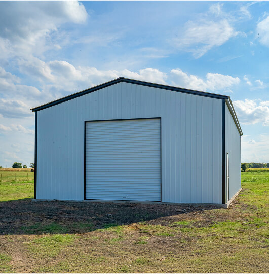 Large white metal building with a garage door