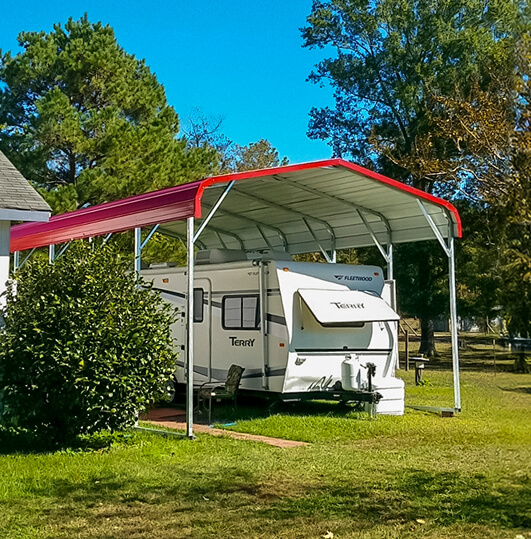 Carport with red regular roof and an RV inside of it