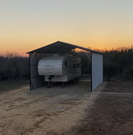 RV under a carport during sunset