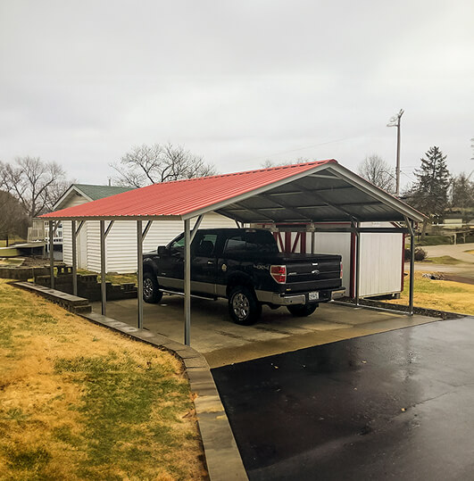 Large carport with a pickup truck inside of it