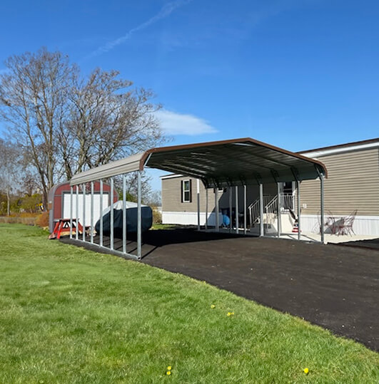 Large carport with a regular roof on a driveway