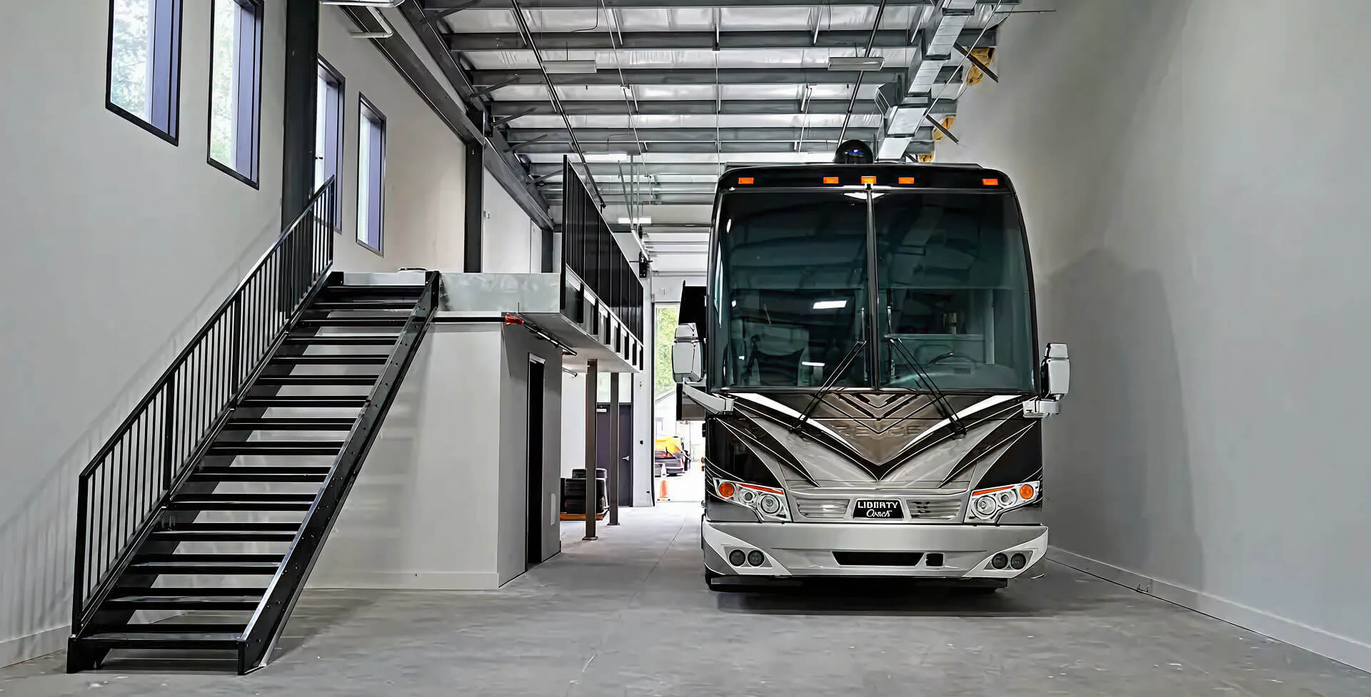 Spacious garage interior with luxury motorhome and upper level