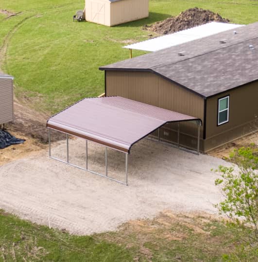 Carport with a brown roof next to a building