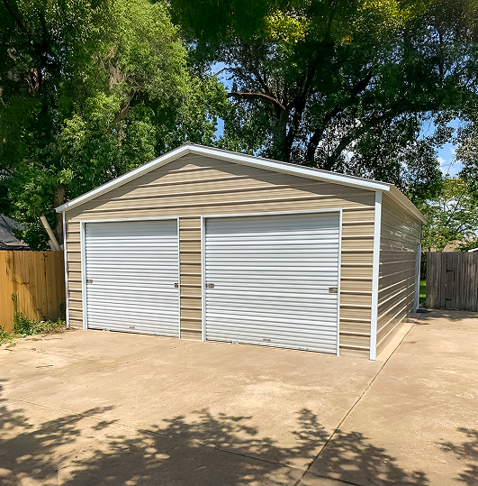 Metal building with two garage doors on a driveway