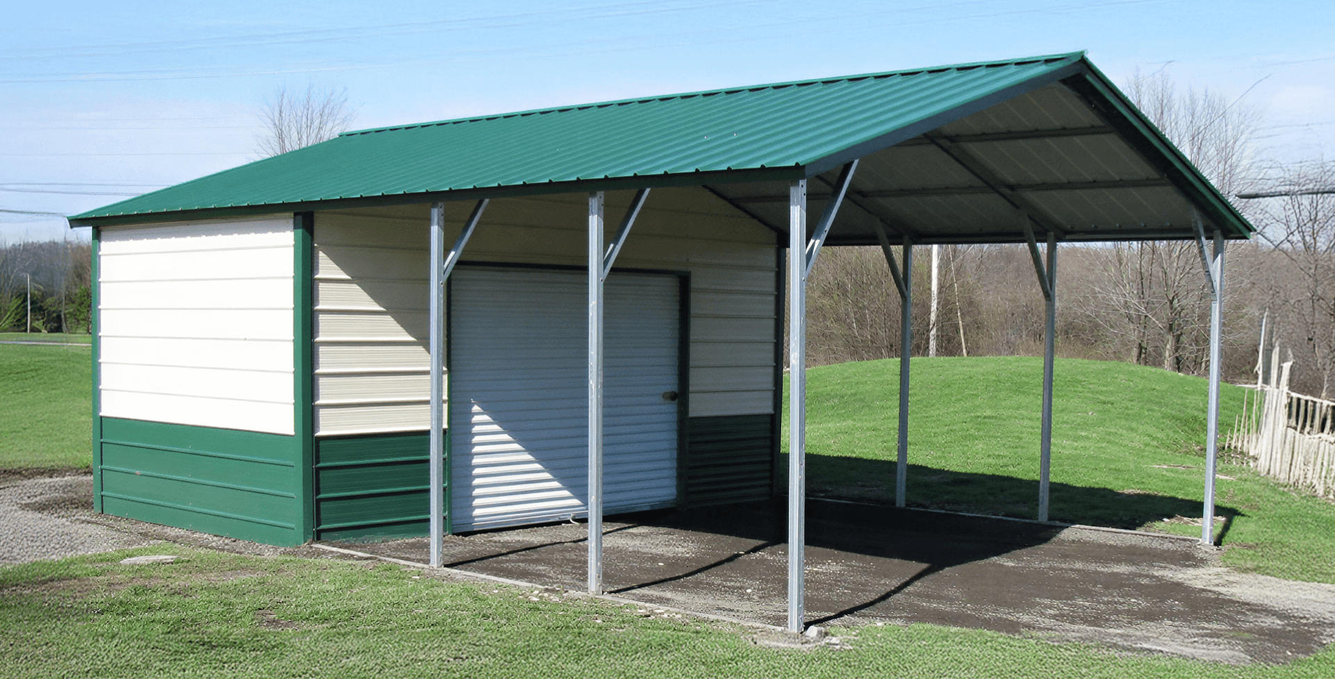 Combination carport and enclosed garage with green-and-cream metal siding and a green roof. The left portion is an open carport with tall steel posts, while the right portion is a fully enclosed garage with a white roll-up door. It sits on a gravel and dirt surface.
