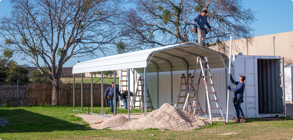 Men constructing a carport on-site