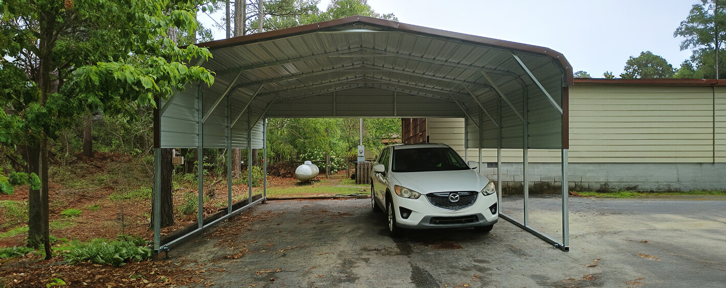 Car parked under a metal carport.