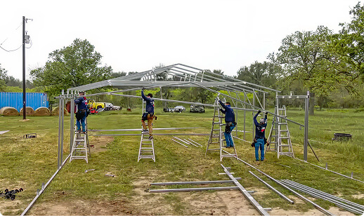 Workers assembling a metal garage frame