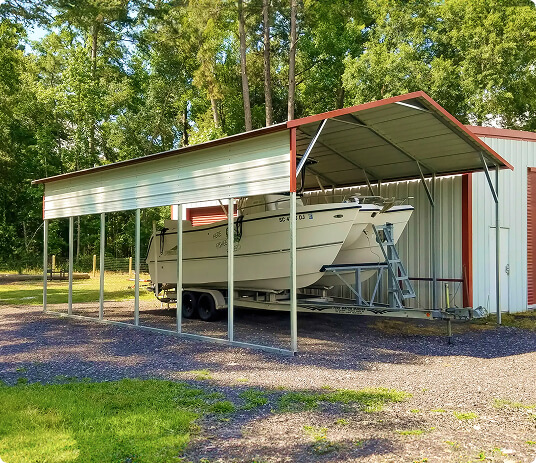 Boat stored under metal shelter.