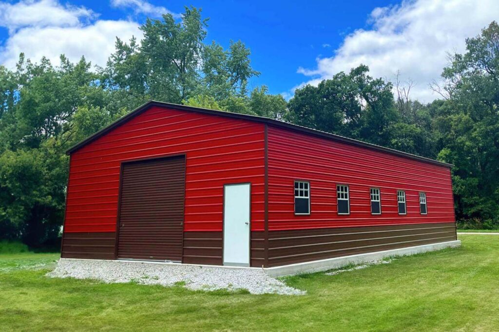Large 30×50 metal garage building with red steel siding and roll-up door, illustrating a spacious steel structure suitable for vehicle storage, workshops, or equipment storage.
