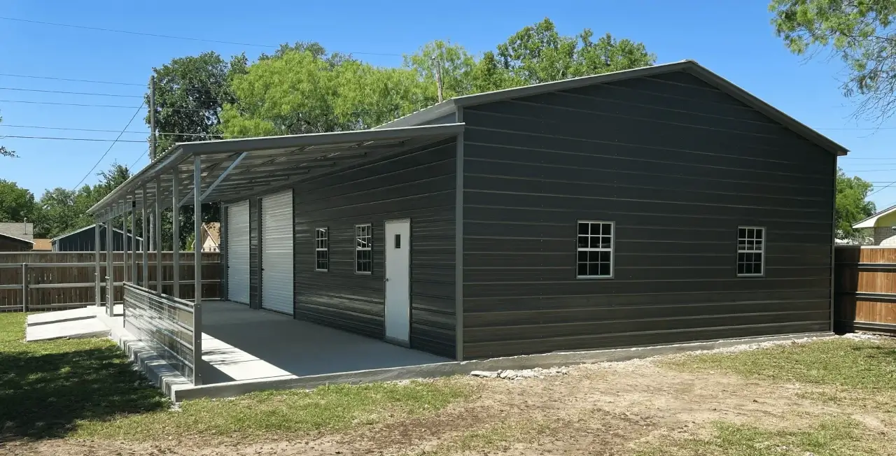 Large metal garage building with roll-up doors and attached lean-to shelter, demonstrating a practical outbuilding design often compared with pole barn and stick-built garage construction.