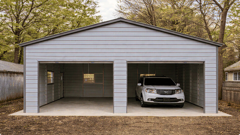 Gray prefabricated 2-car metal garage with two open bays and a white SUV parked inside, demonstrating typical double garage dimensions for residential vehicle storage.