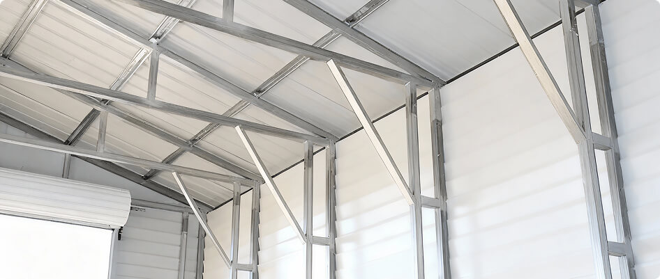 Interior view of a 60x100 metal building showing clear-span steel framing and vertical wall panels for commercial use