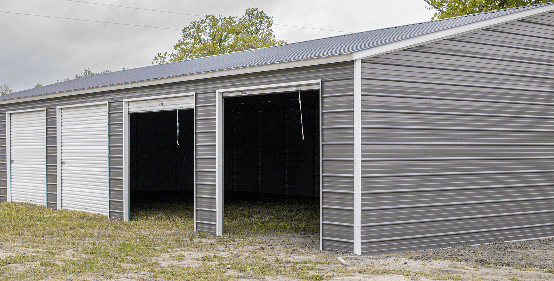 Detached 4-bay metal garage with four wide openings, ideal for parking four vehicles with side-by-side access and extra storage space.