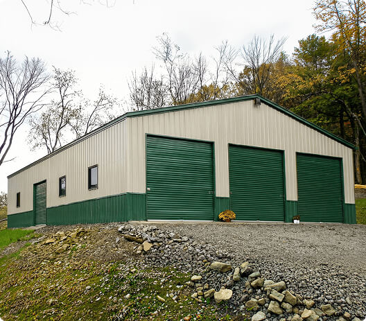Fully enclosed 60x100 metal building with vertical panels and multiple roll-up doors used for commercial storage