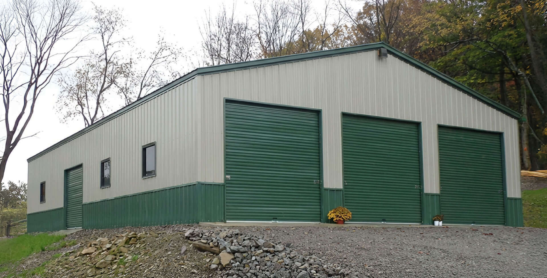Fully enclosed 50×60 metal building with vertical siding and multiple garage doors, suitable for equipment storage or workshop use.