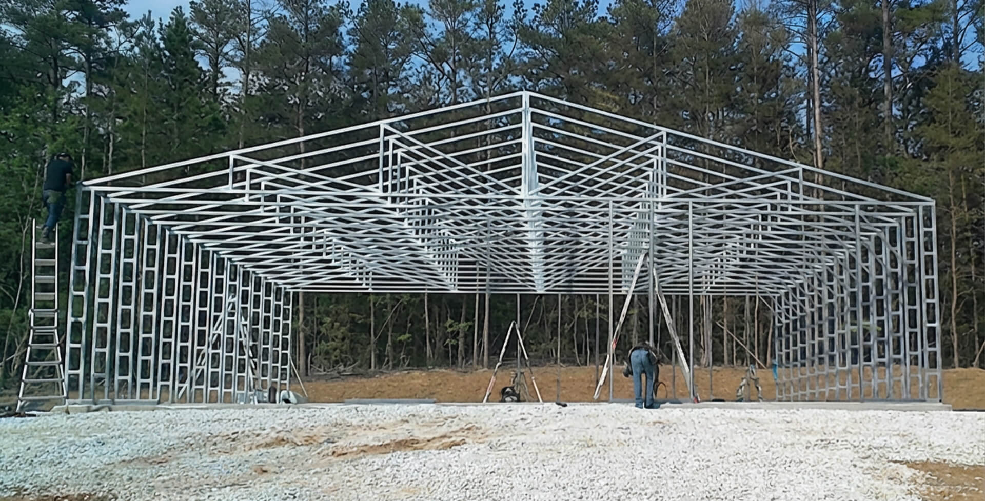 Steel framing installation of a 50×60 metal building, showing clear-span truss design before wall and roof panels are added.