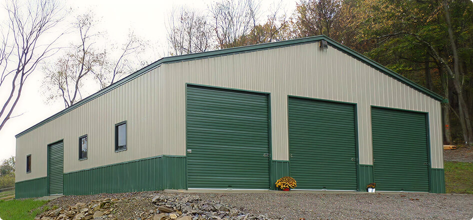 A three-car garage with green garage doors